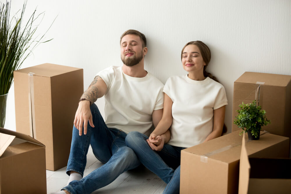 a young couple in their new home with boxes.